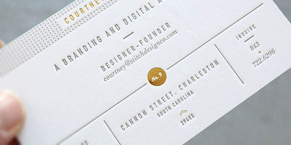 Debossed business card displaying a postal address